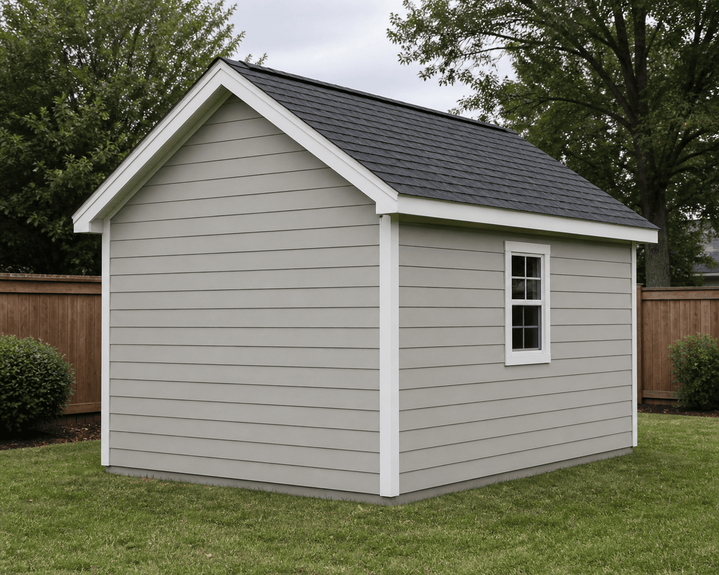 Three-quarter rear preview of the 10 by 12 gable shed with a blank rear gable, one right side window, greige lap siding, and dark charcoal shingles